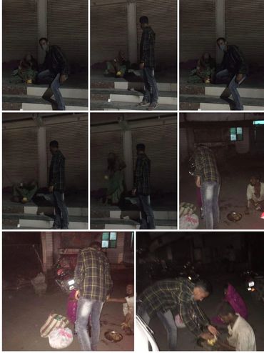 A man in a mask giving food to homeless people at night on the street.