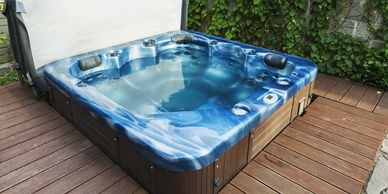 hot tub on an exterior wooden deck