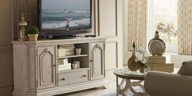 white traditional styled media console with tv sitting on it