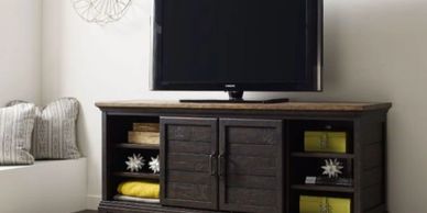 dark brown media console with tv sitting on top