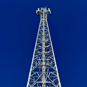 Tall metal communication tower against a clear blue sky.