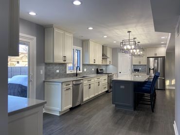 Kitchen remodel with white cabinet and island seating 