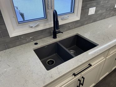 Kitchen remodel with white cabinet and black undermount sink 