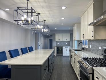 Kitchen remodel with white cabinet and island seating 