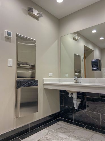 Bathroom remodel with stainless steal trash can and double bowl vanity