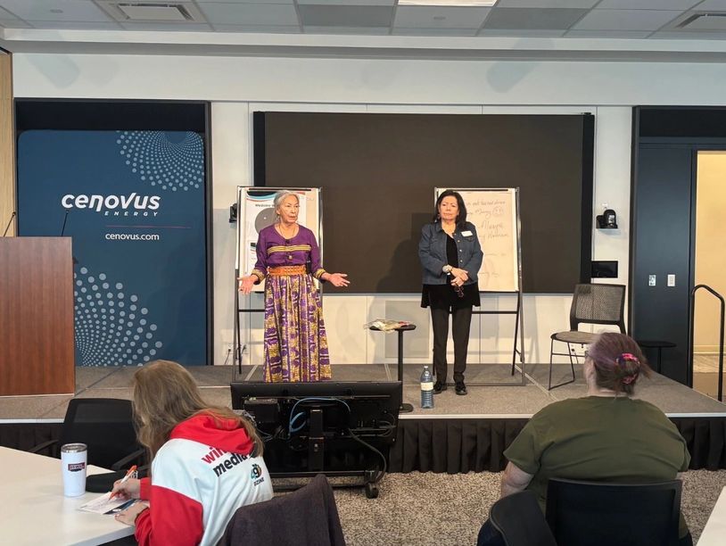 Joyce Healy and Marilyn Shingoose Lead standing on stage as they lead a workshop.
