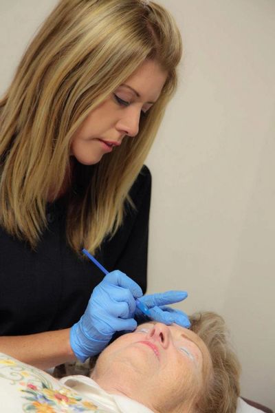 Lindi during a permanent makeup session.