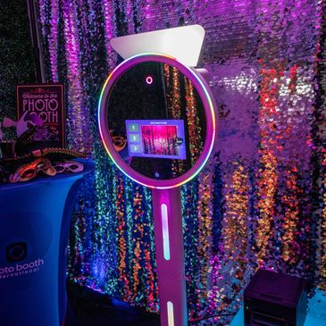 Image of a selfie ring light mirror photo booth, featuring a large mirror surrounded by LED lights