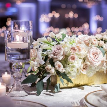 A white and lavender elegant floral arrangement centerpiece display.