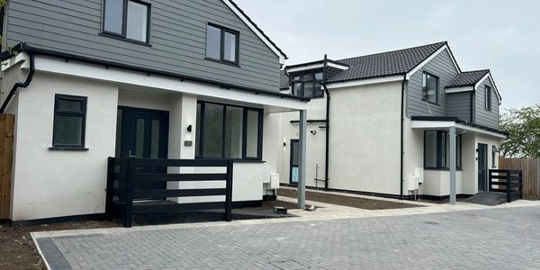 Two modern houses with gray and white exterior.