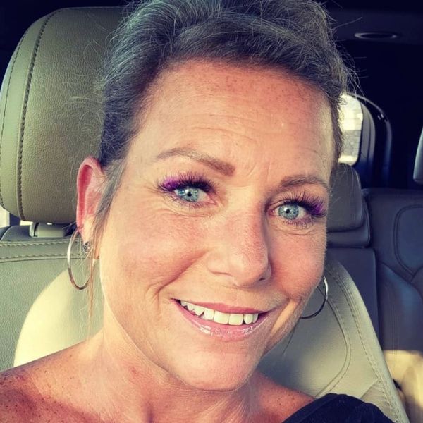 client selfie showing her purple colored lashes