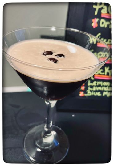 Espresso martini with coffee bean garnish in a cocktail glass.