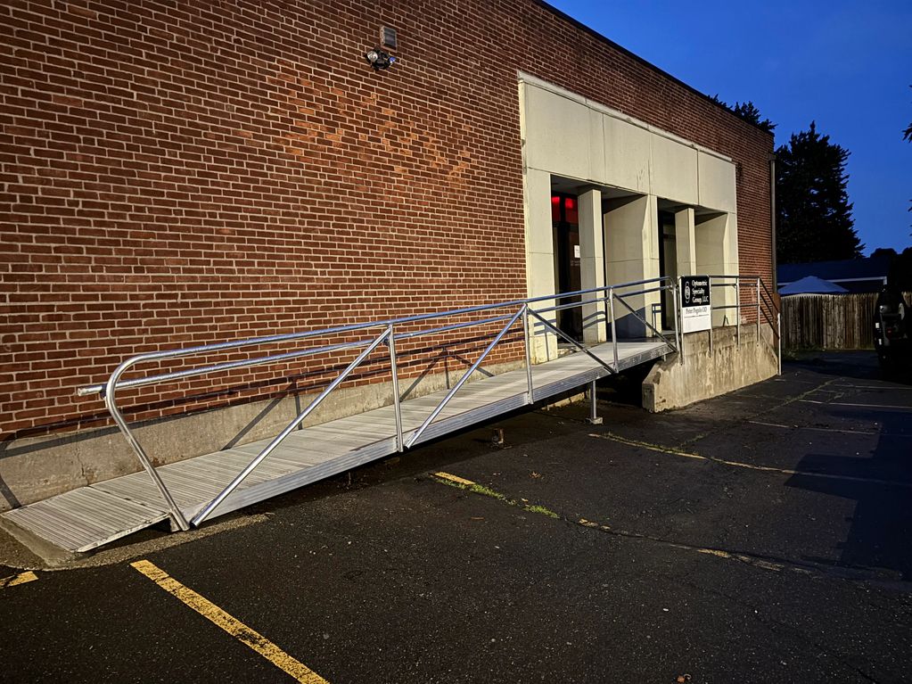 Wheelchair ramp and new aluminum railings.
