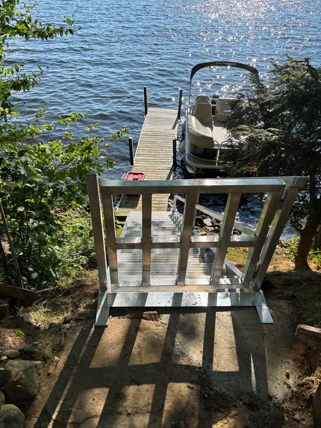 Lakefront aluminum staircase with latched swing gate.