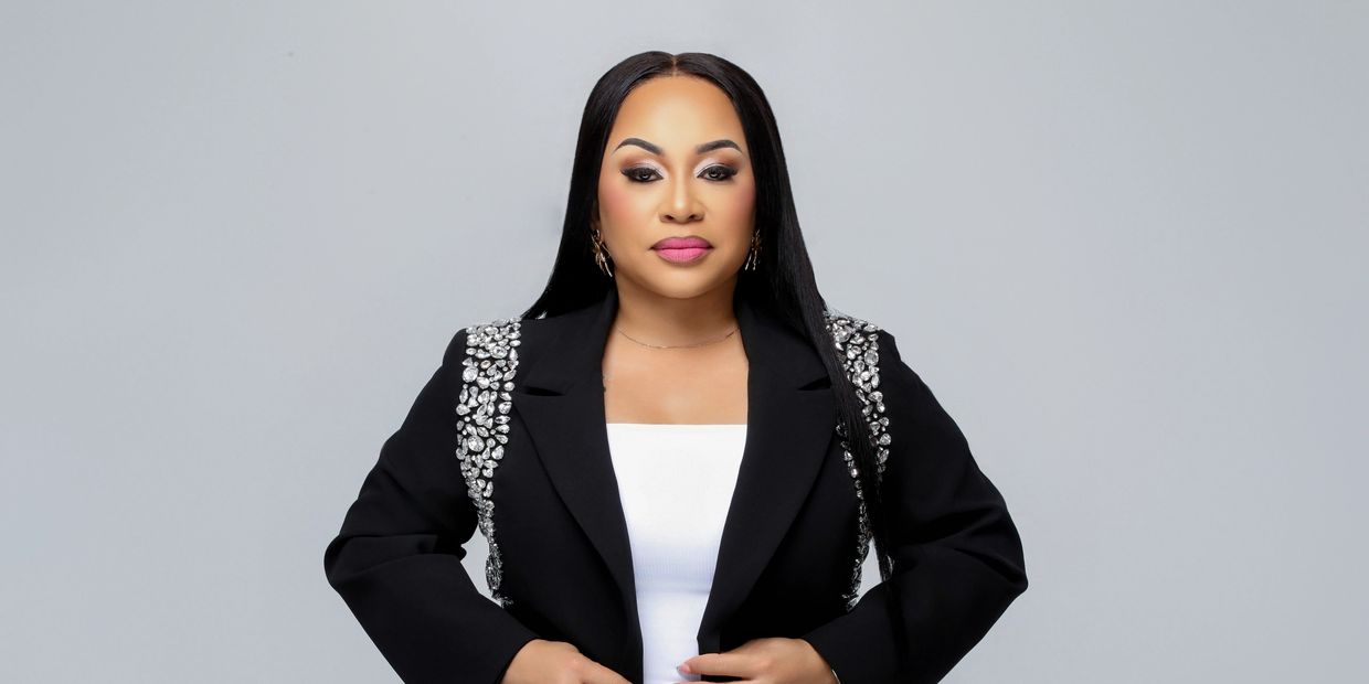 Woman in black blazer with embellished shoulders.