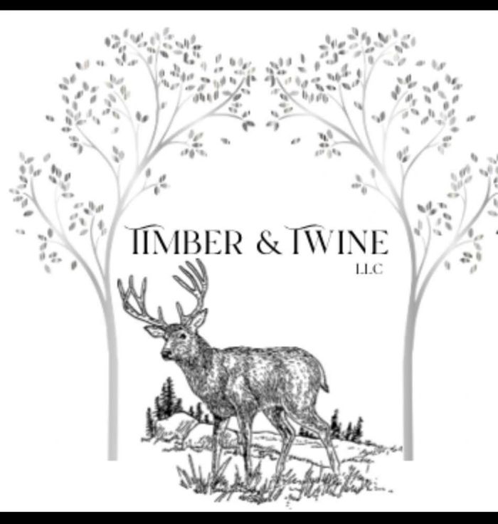 Black and white logo featuring a deer under two arched trees with the text Timber & Twine LLC.