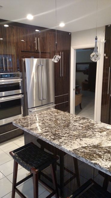 Beautiful remodeled kitchen with dark cabinetry and a gorgeous granite countertop.