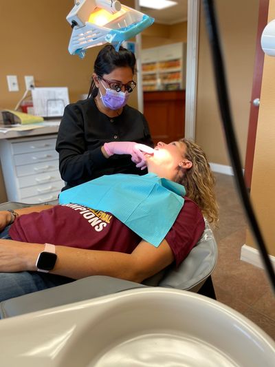 Dentist Farrah Beg examining a patient for a dental crown procedure. 