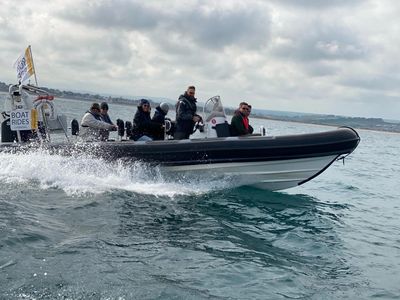 Powerboat at speed with a group of customers