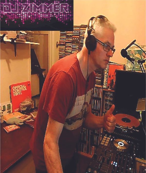 DJ Zimmer in a home studio with headphones and DJ equipment.