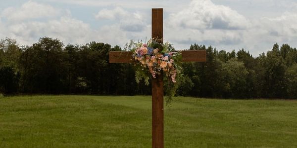Wooden wedding cross decorated with colorful flowers