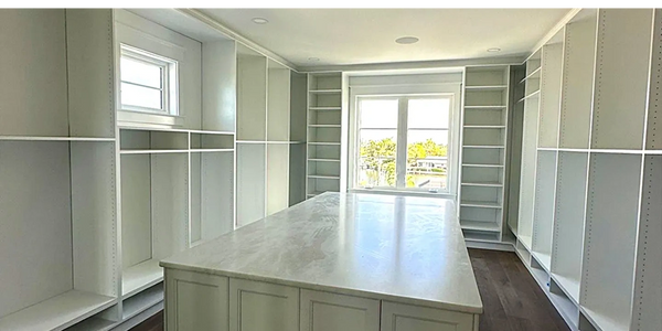 Custom large walk-in closet with a modern design.