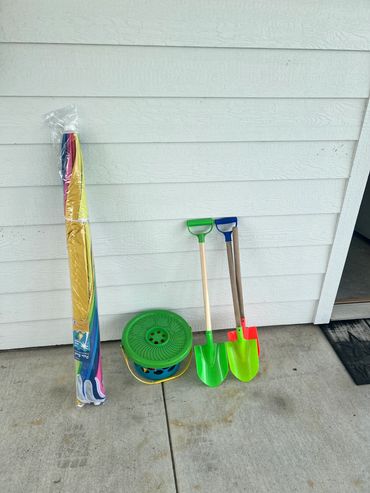 Some of the sand toys and one of the beach umbrellas available for your use.