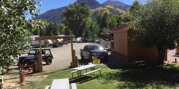 RVs and a few picnic tables at a campground