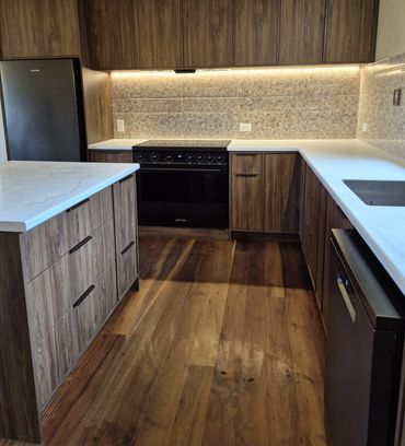 Completed Tangiteroria custom kitchen with timber cabinetry, laminate benchtop, tiled splashback