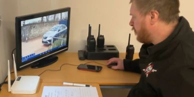 Man monitoring a security camera feed.