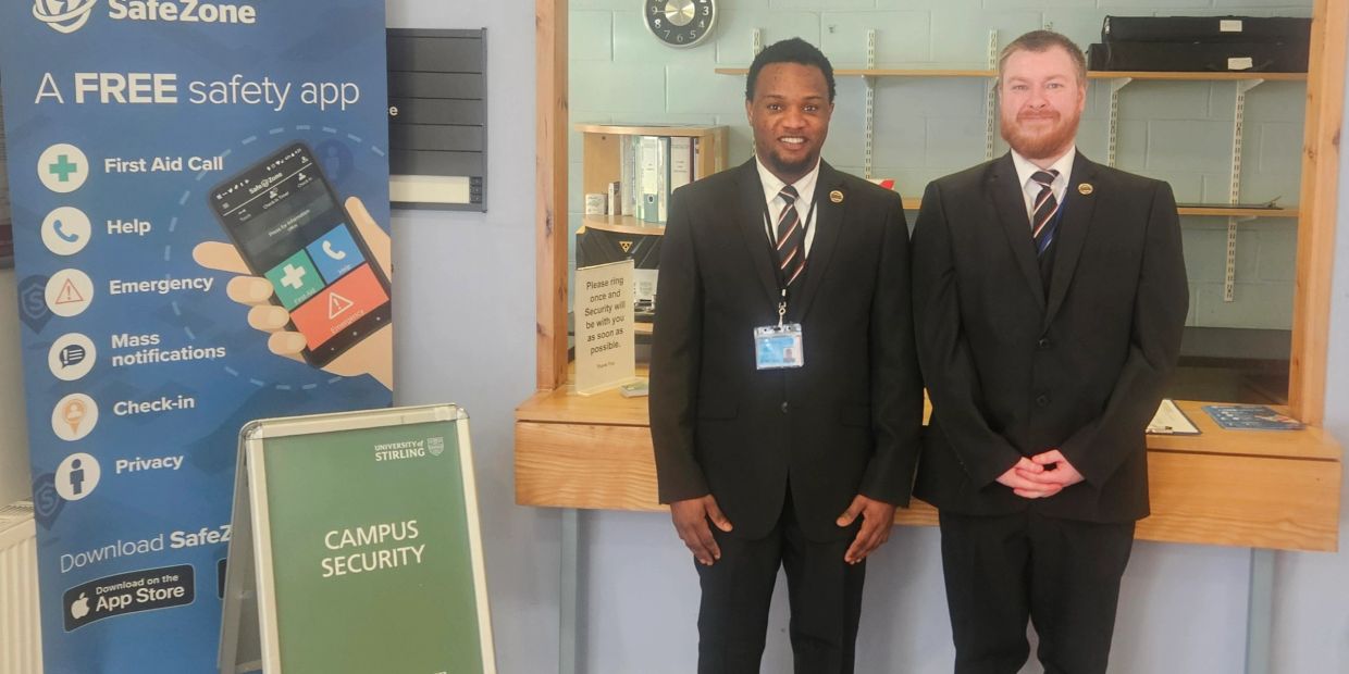 Two campus security officers standing inside a building.