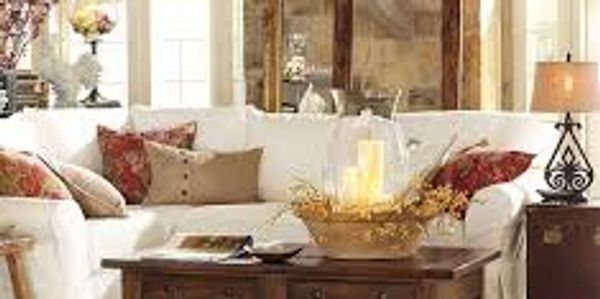 Cozy living room with white sectional sofa and decorative pillows.