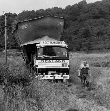 Scania 111 large boat mould in long grass field in the English summer Sealand boat deliveries