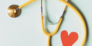 An image of a stethoscope with a red heart near it.
