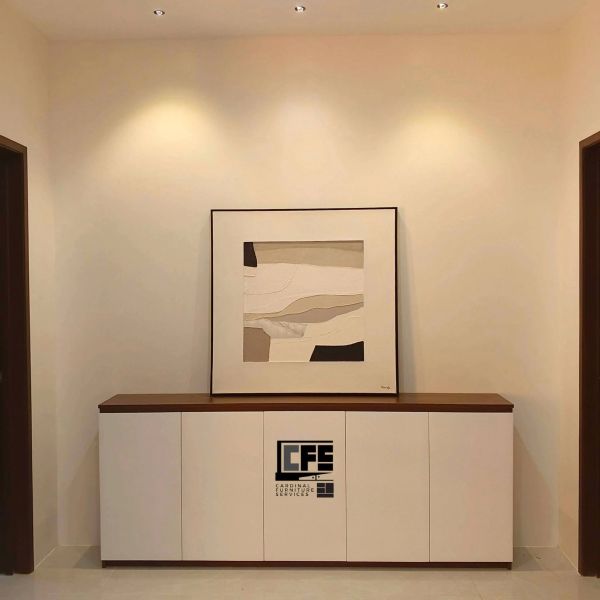 Minimalist hallway with a modern sideboard and abstract wall art.