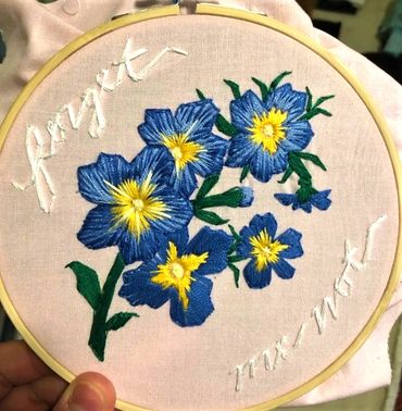Embroidery of forget-me-not flowers
