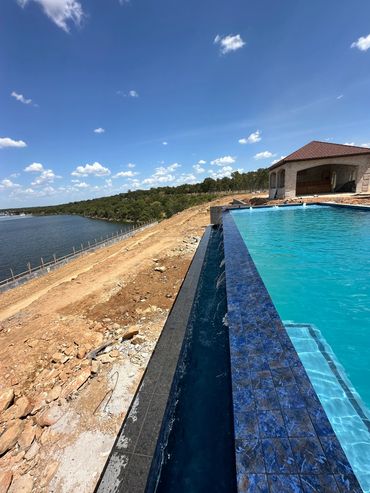 Infinity pool overlooking a lake.