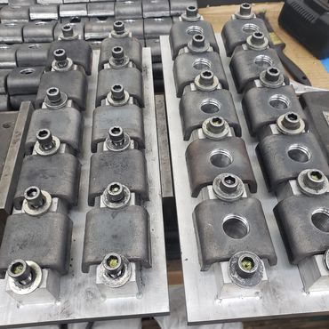 Parts in jigs ready to be drilled and tapped.