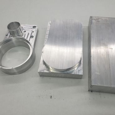Three stages of CNC milled aluminum part