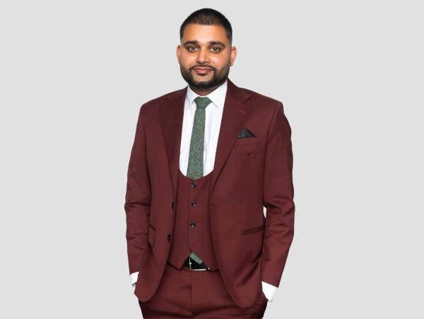Man in a maroon suit with green tie.
