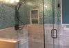 Custom Frameless Shower Door with Notched Panel on Step up 