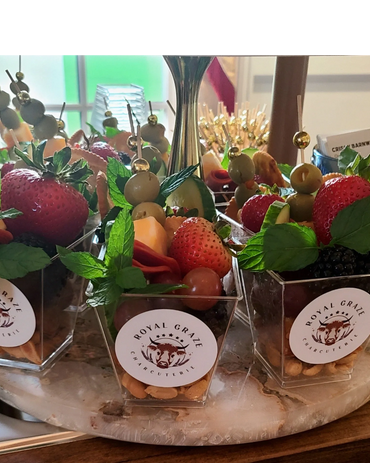 Elegant charcuterie cups with fresh fruit, olives, and mint from Royal Graze.