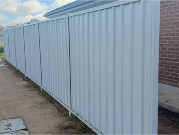 A sleek Colorbond side fence made from durable steel panels, running along the property boundary to provide privacy, security, and a modern, low-maintenance finish to the side yard.