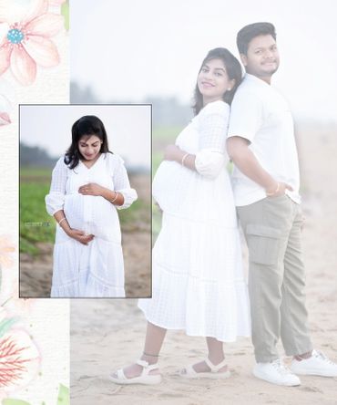 Pregnant woman in white dress with her partner on a sandy beach.