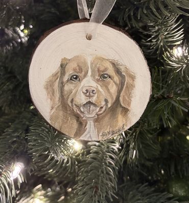 Watercolor painting of a dog on a wooden Christmas ornament