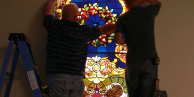 Installing stained glass.