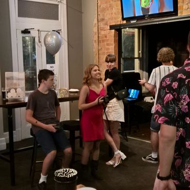 Group of young people socializing indoors at a casual gathering.