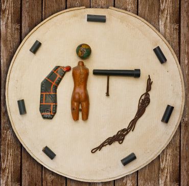 A round board with various vintage objects arranged on it.