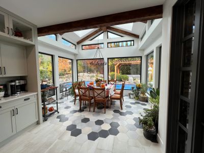Bright dining area with skylights and hexagonal floor tiles.
