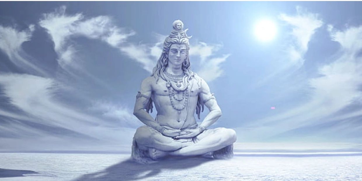 A serene statue of Lord Shiva meditating under a bright sky.